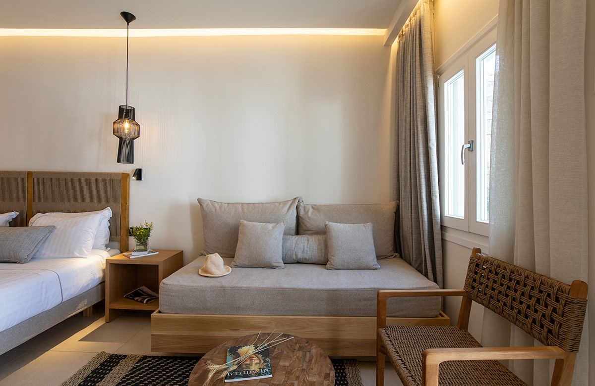 Comfortable sitting area with sofa and natural light at Damianos Hotel in Mykonos Town