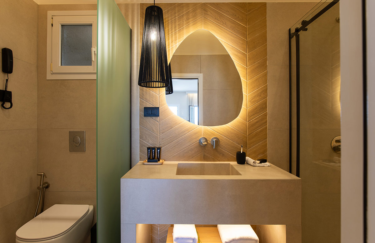 Elegant bathroom design with sculpted mirror and walk-in shower at Damianos Hotel in Mykonos Town