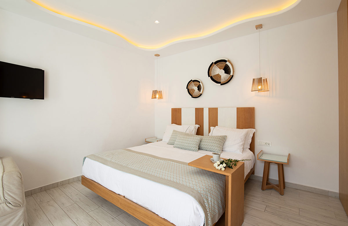 Classic Room with double bed, warm ambient lighting and minimal design at Damianos Hotel Mykonos Town