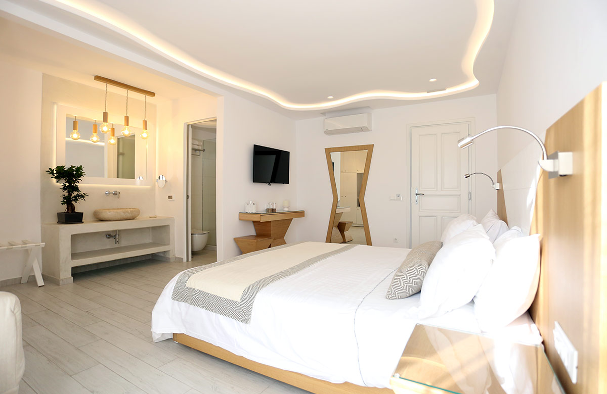 Open-plan interior with curved ceiling lighting and refined design at Damianos Hotel in Mykonos Town