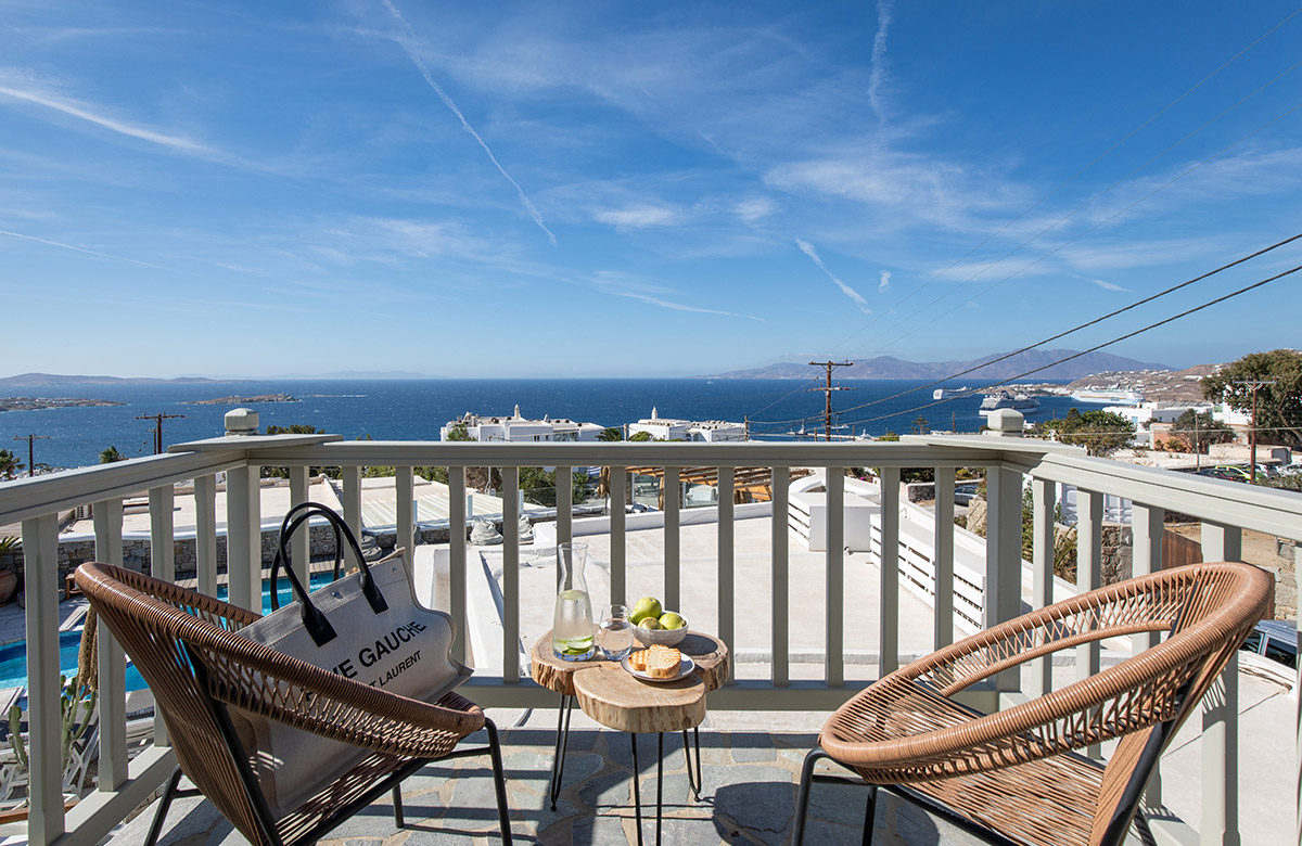 Private balcony of a deluxe hotel room in Mykonos Town with Aegean Sea view