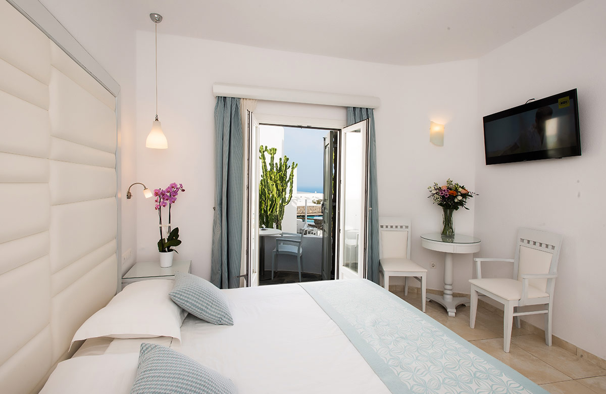 Classic Room with open balcony access and interior seating at Damianos Hotel Mykonos Town