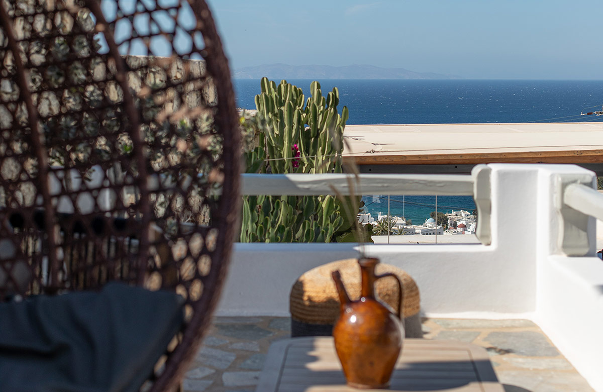Private balcony with Aegean Sea horizon view and outdoor seating at Damianos Hotel in Mykonos Town