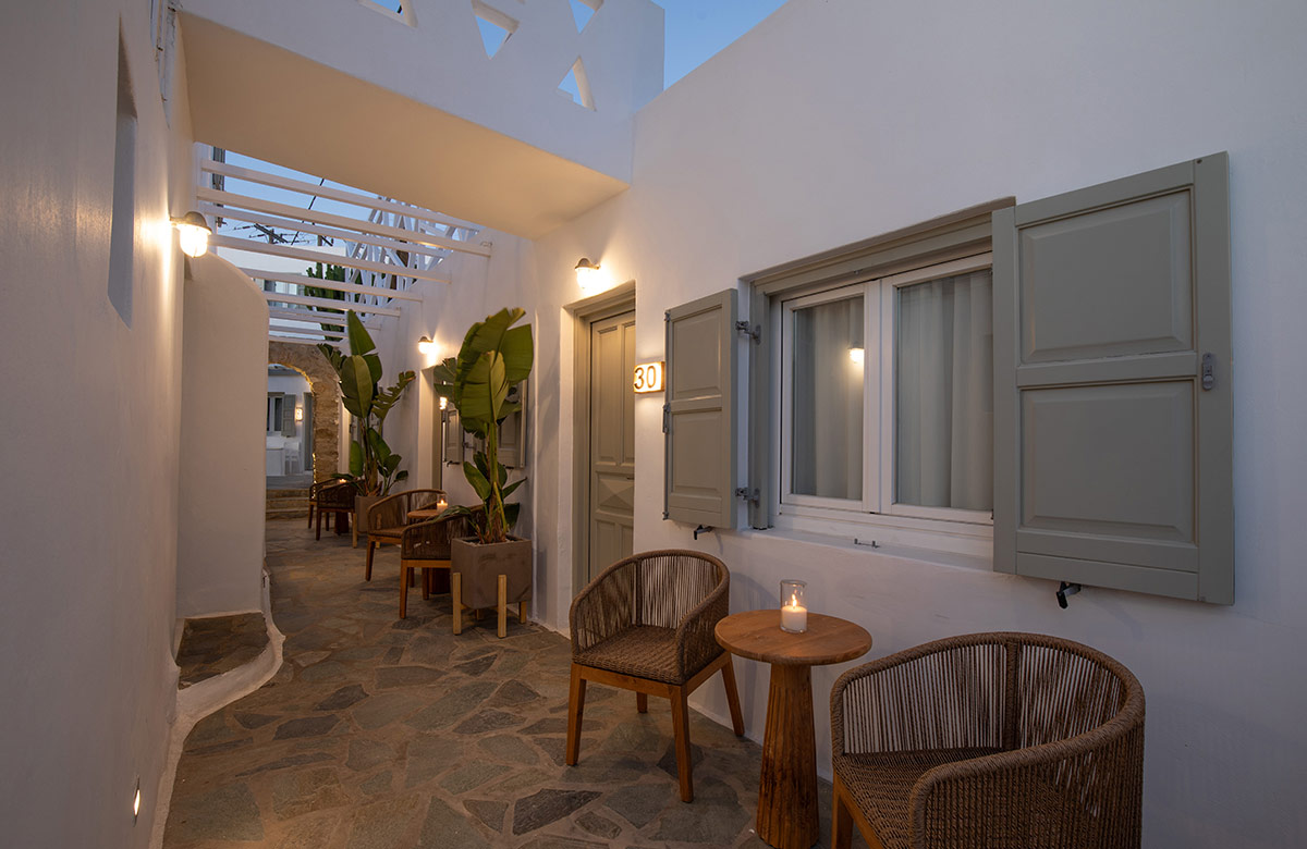 Evening courtyard seating outside triple standard room in Mykonos Town hotel
