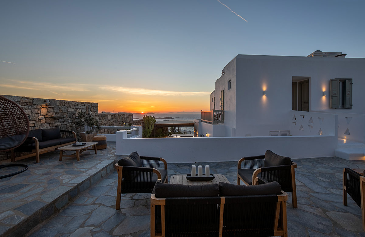 Sunset view from the outdoor lounge area at Damianos Hotel in Mykonos Town overlooking the Aegean Sea