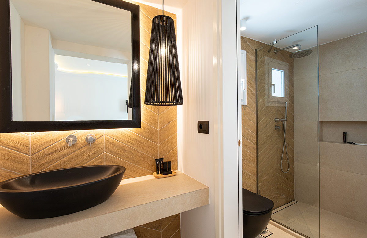 Classic Room bathroom with walk-in shower, natural wood details and minimalist design at Damianos Hotel Mykonos Town