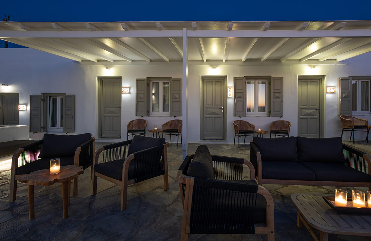 Evening courtyard lounge at Damianos Hotel in Mykonos Town with softly lit outdoor seating