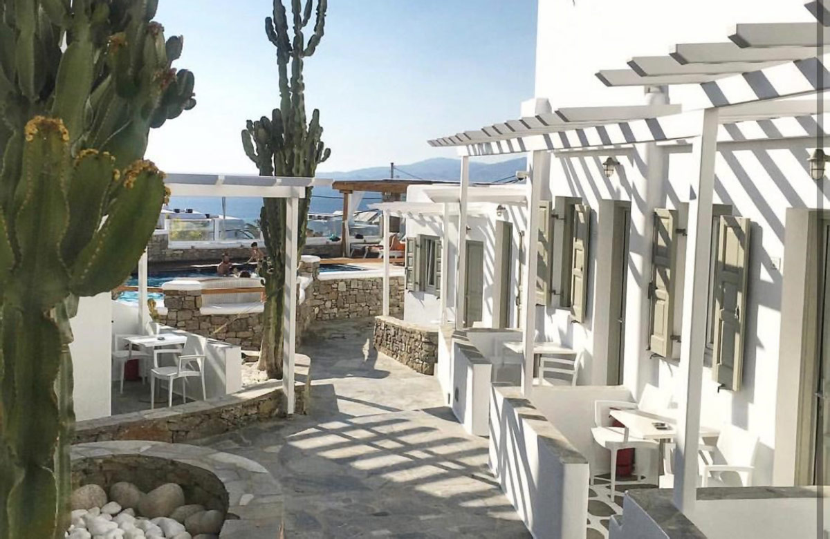 Classic Room exterior with private veranda, white Mykonian architecture and courtyard pathways at Damianos Hotel Mykonos Town
