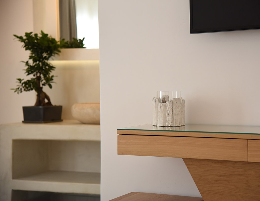 Minimal interior detail in a deluxe hotel room in Mykonos Town with natural materials and soft lighting