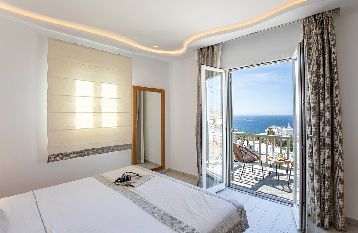 Deluxe hotel room in Mykonos Town with private balcony and Aegean Sea view
