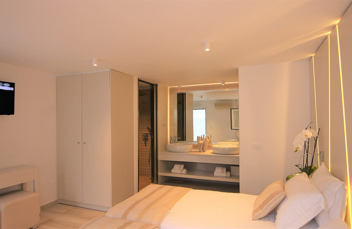 Cozy Small Room No View at Damianos Hotel in Mykonos Town with double bed, soft lighting and minimalist indoor design