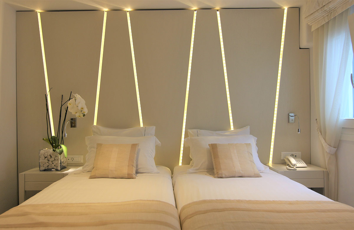 Cozy Small Room No View at Damianos Hotel in Mykonos Town with twin beds, ambient lighting and minimalist headboard design
