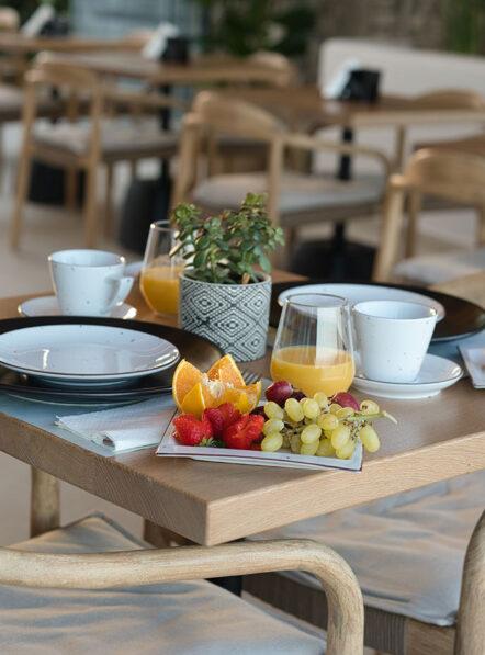 Breakfast salon table at Damianos Hotel in Mykonos Town with fresh fruit and morning drinks
