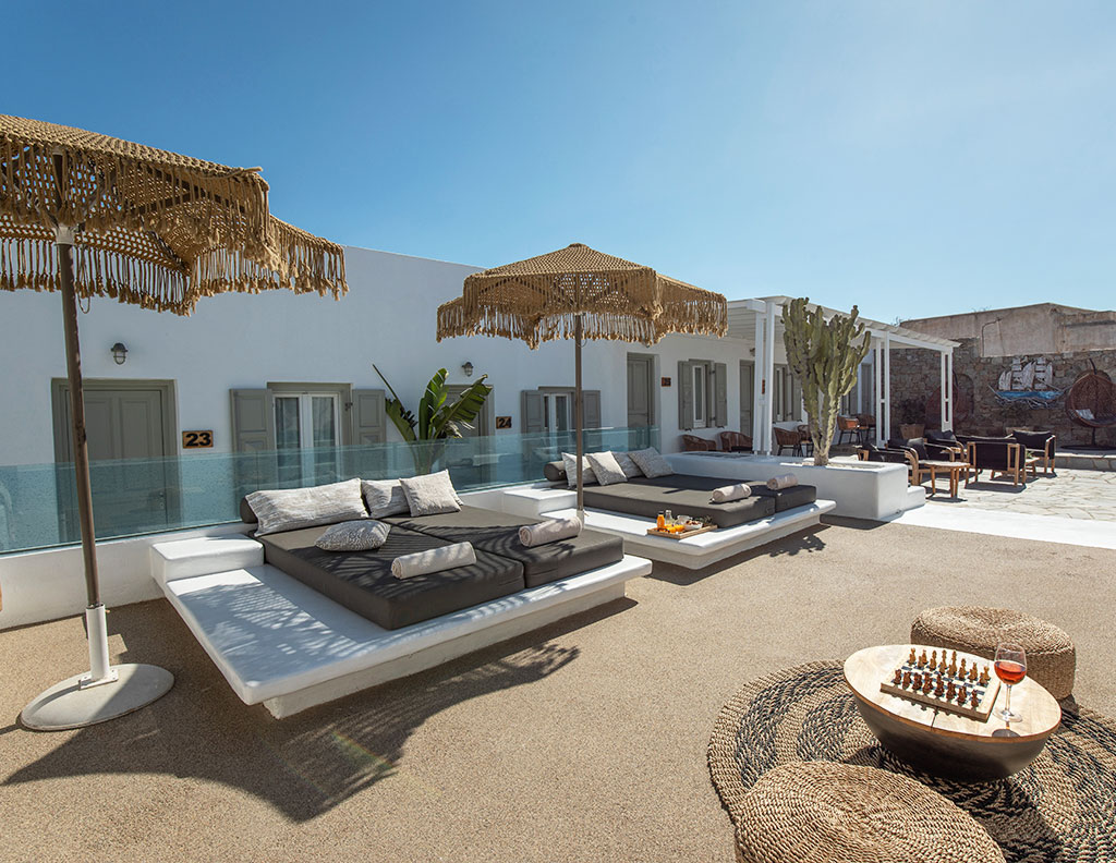 Sun lounge with daybeds at Damianos Hotel in Mykonos Town, designed for relaxed outdoor moments